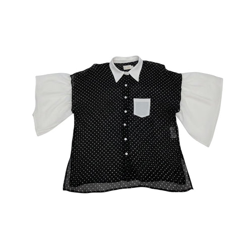 Tralulu blusa preta com padrão de bolinhas brancas e mangas compridas brancas. Colarinho clássico e bolso frontal.