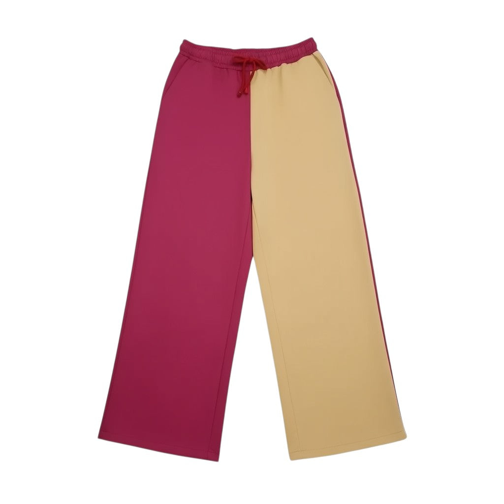 Calças desportivas largas Tralulu color block em cetim, rosa choque e bege, com cintura elástica e cordão.