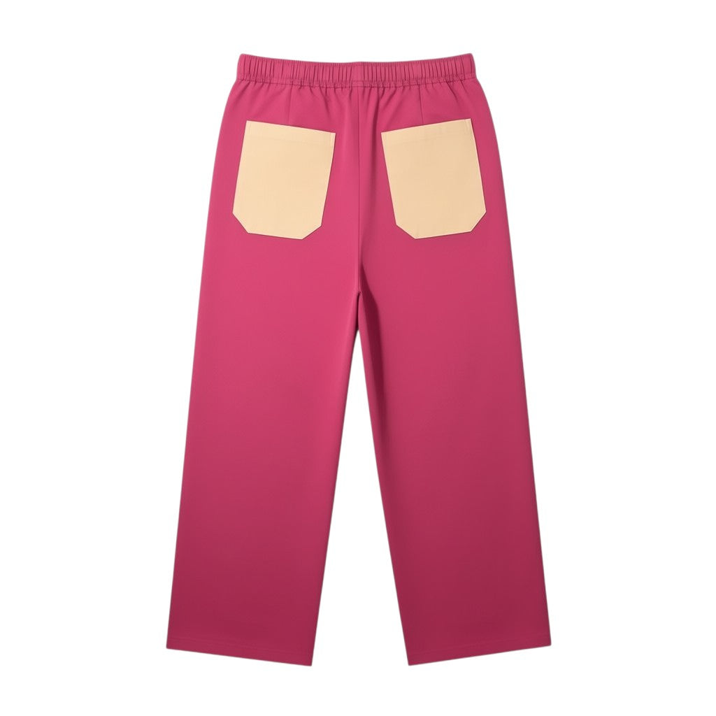 Calças desportivas largas Tralulu em cetim rosa choque e bege com dois bolsos traseiros.