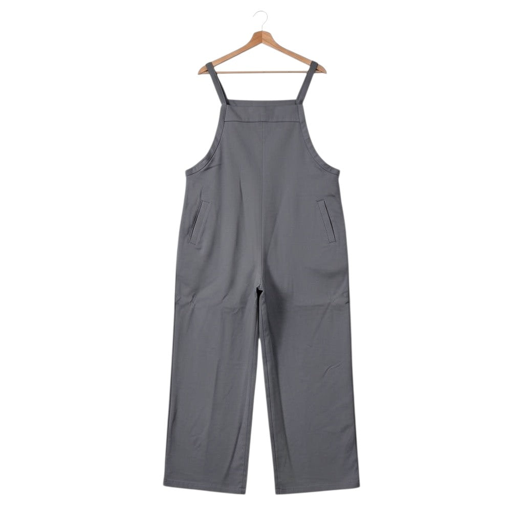 Jardineira Tralulu cinzenta de corte largo com alças ajustáveis e bolsos laterais, ideal para um look casual e moderno.
